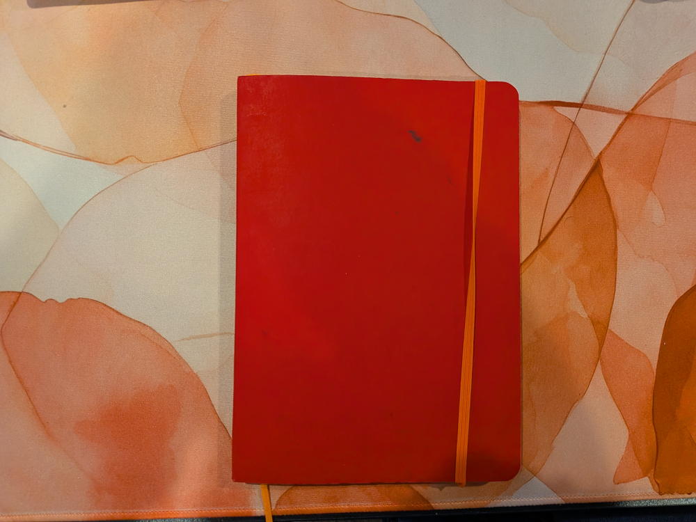 red journal on a desk