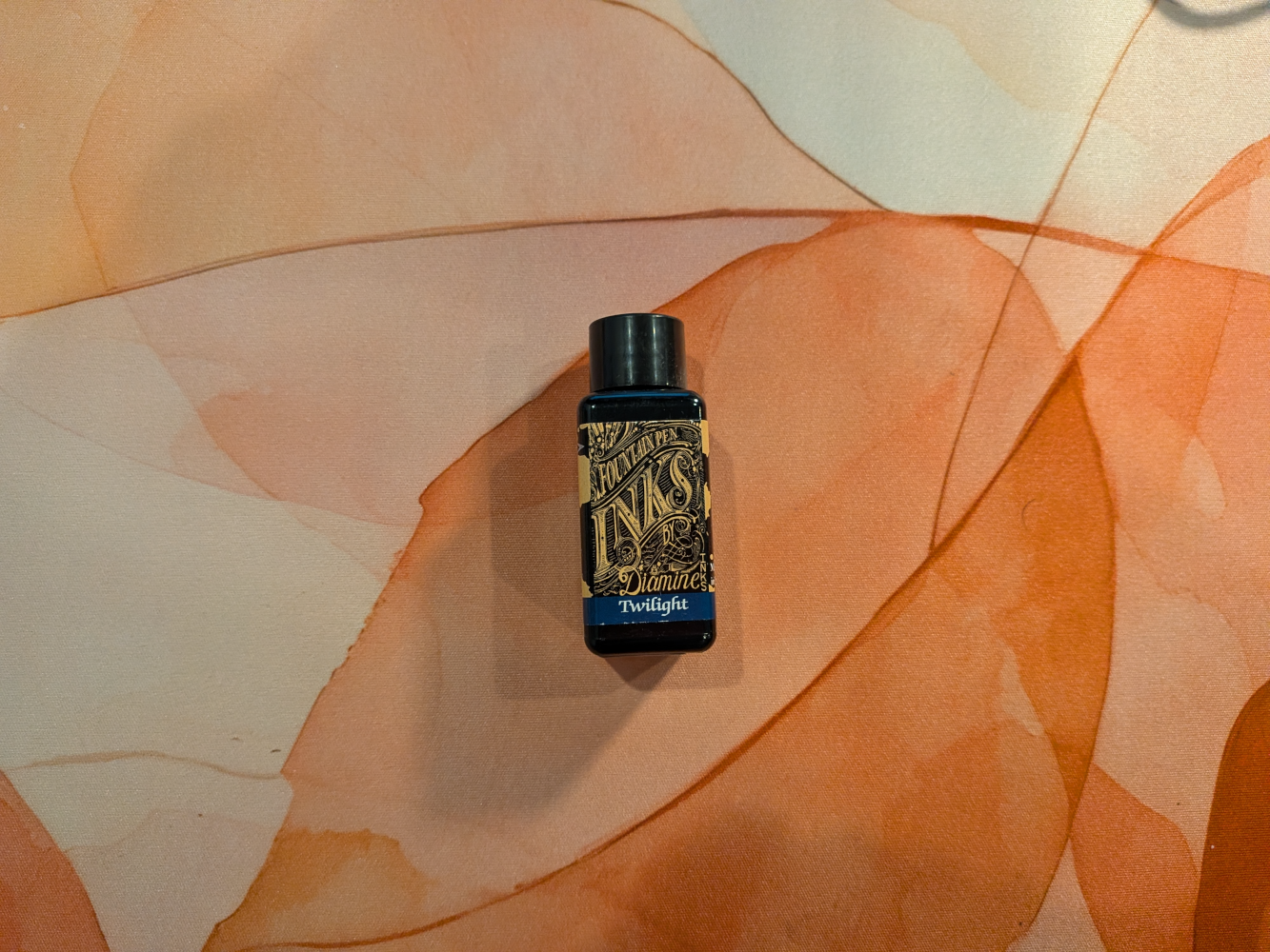 bottle of dark ink on a desk