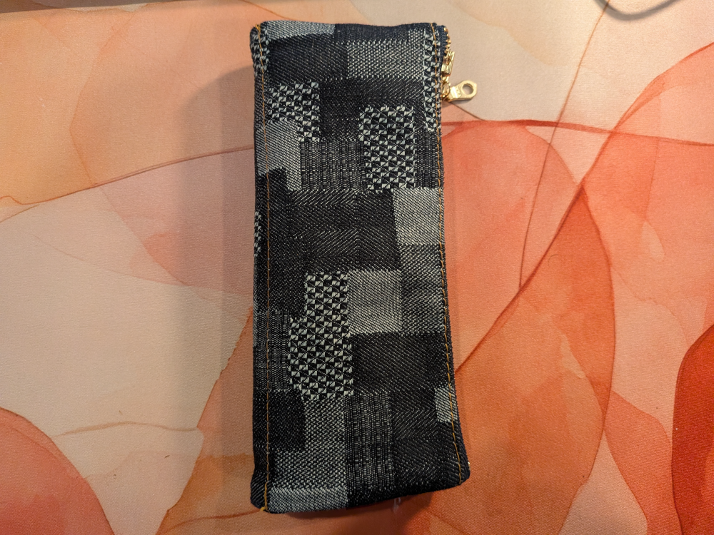 patchwork denim pouch lying on a desk